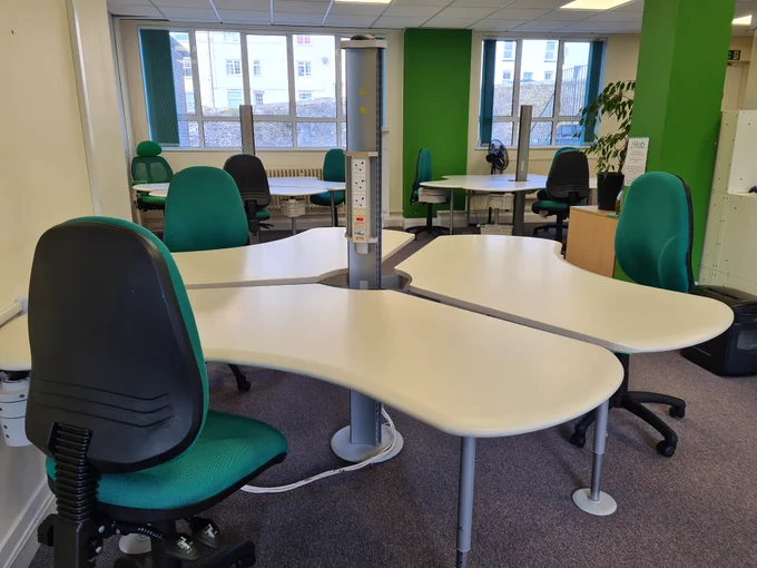 Coworking space with desks and chairs.