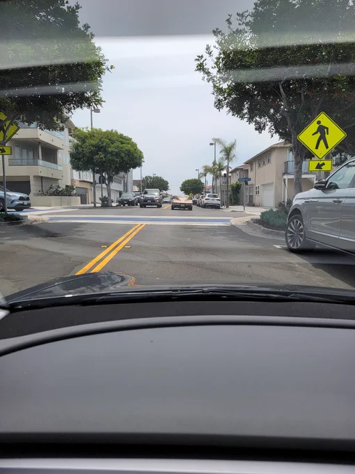 A 1963 "Split Window" Corvette heads down to Laguna Beach. Pic taken from 2023 Tesla. While capturing one scene, another scene in the mind plays off of Red Barchetta by Rush. And, I try to explain it all to my son...who gets it!
