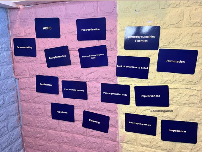Flash cards stuck on a blue, pink and yellow painted brick style wallpaper.

The following words are written on the flashcards

- ADHD
- Easily Distracted
- Hyperfocus
- Fidgeting
- Impulsiveness
- Impatience 
- Interrupting others
- poor organisation skills
- rumination
- poor working memory 
- rejection Sensitive dysphoria 
- lack of attention to detail
- difficulty sustaining attention 
- Restlessness 
- excessive talking 
- procrastination