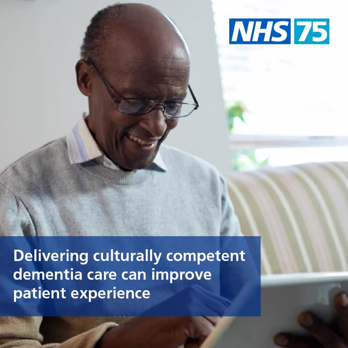 A black bald man with glasses looks down at a tablet device, he is smiling. The text reads ‘Delivering culturally competed dementia care can improve patient experience.’ There is a logo which reads ‘NHS 75’ in the corner.