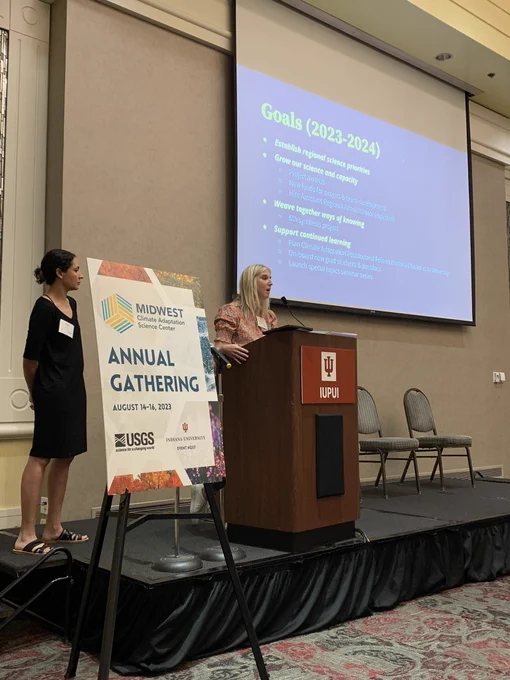 Olivia LeDee and Jessica Hellmann present on stage.