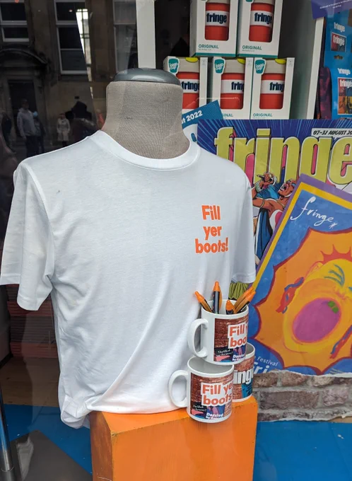 Fill yer boots white t-shit and mugs on display in the Fringe Shop. 