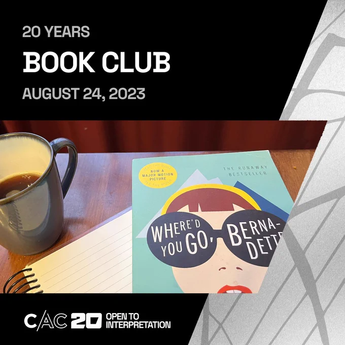 A dark wood table in front of red curtains. On the table is a half-full blue mug of coffee, a spiral notebook open to a blank page, and the book "Where'd You Go, Bernadette?"
