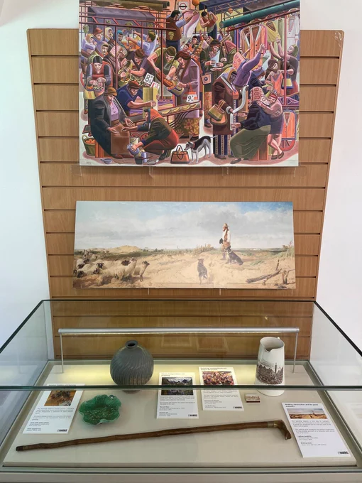 Images of our collections such as paintings and a display case with objects in it at Freckelton Library 