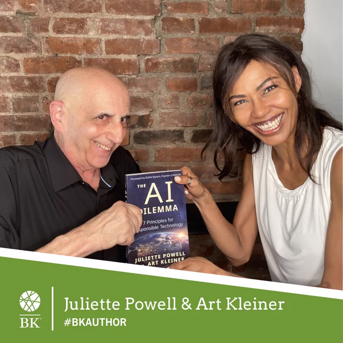 Art Kleiner and Juliette Powell smile and together hold a copy of their new book, The AI Dilemma.
