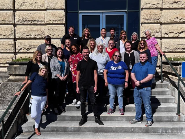 A group of employees smiling in front of the Water Treatment Plant.