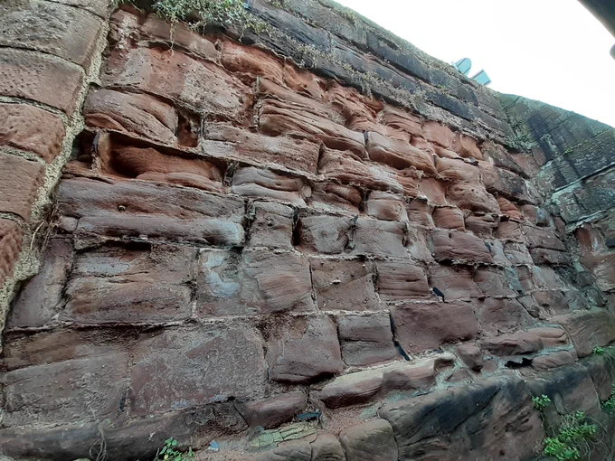 An example of hard cement mortar standing proud between eroded sandstone