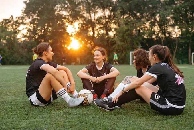 Athletes Sitting on Grass