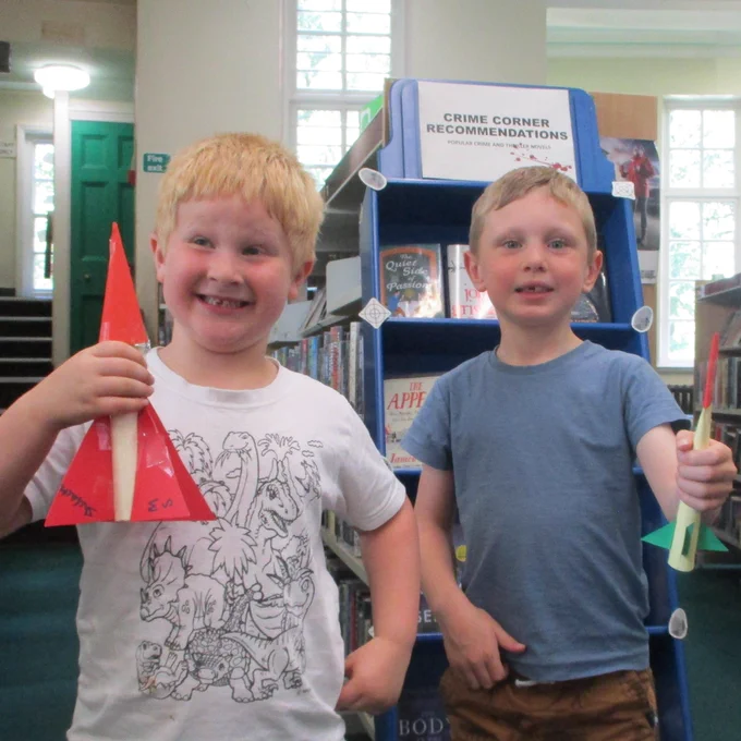 two boys with carboard rockets