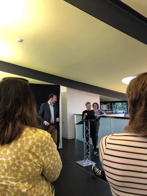 Decorative image: Irish consulate member giving a speech next to a BSL interpreter in the Scottish poetry library