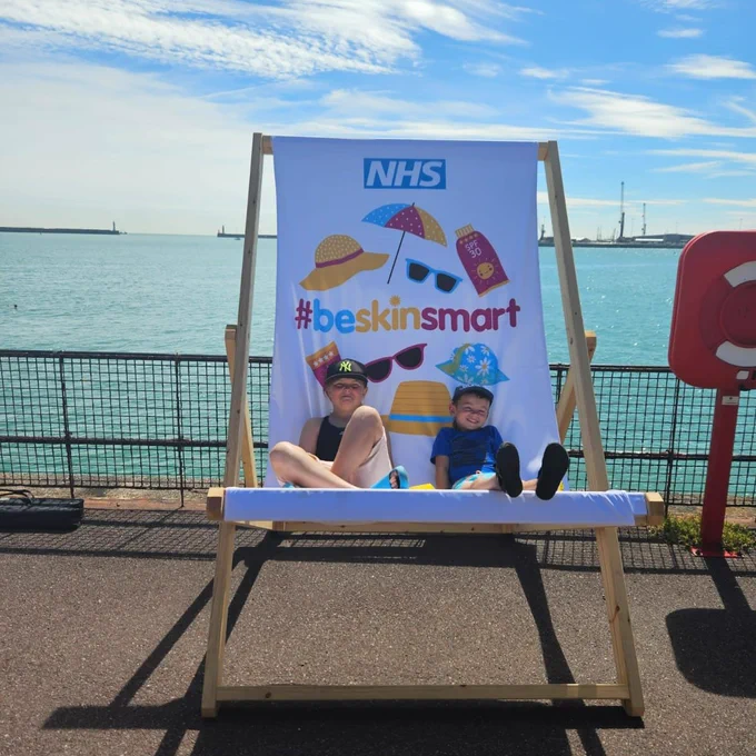 Two children on the giant #beskinsmart deck chair