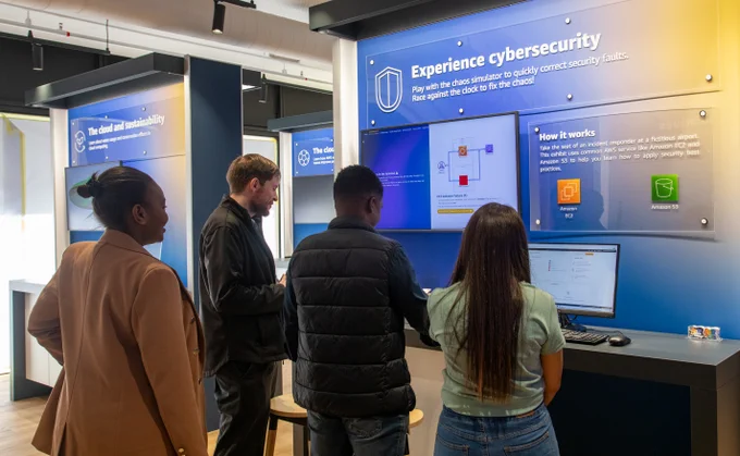People looking at a cybersecurity exhibit at the AWS Skills Center in Cape Town, South Africa.