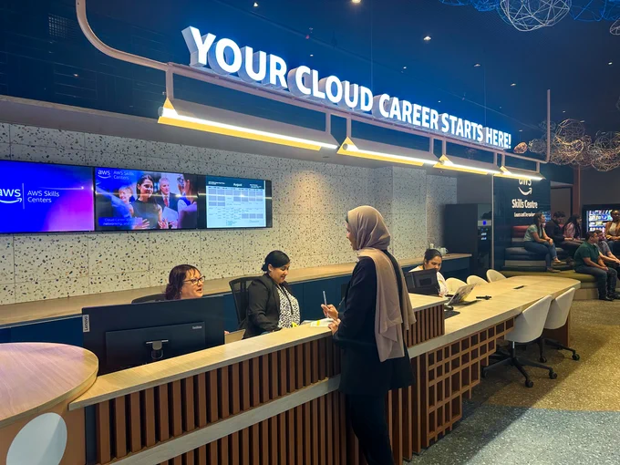 The front desk of the AWS Skills Center in Cape Town, South Africa. Above the desk is a sign that reads "YOUR CLOUD CAREER STARTS HERE." 
