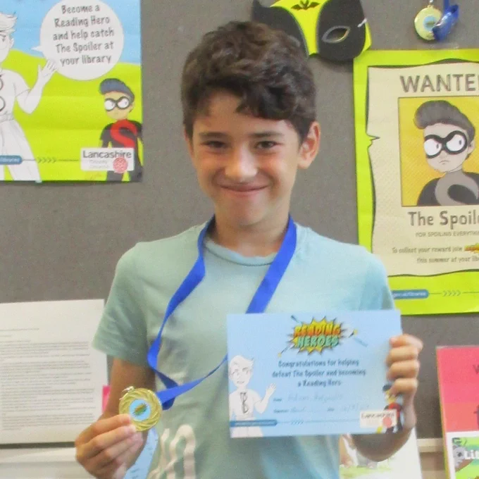 boy with certificate and medal