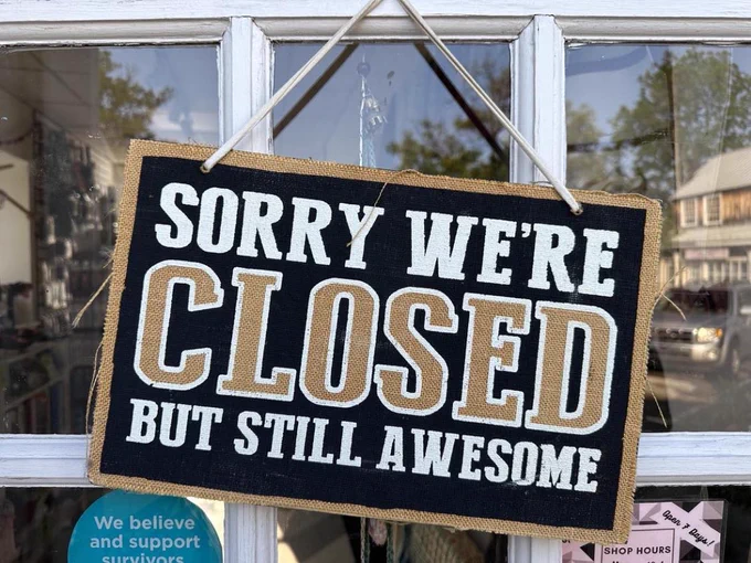 Sign hanging outside a store that reads: "Sorry we're closed but still awesome".