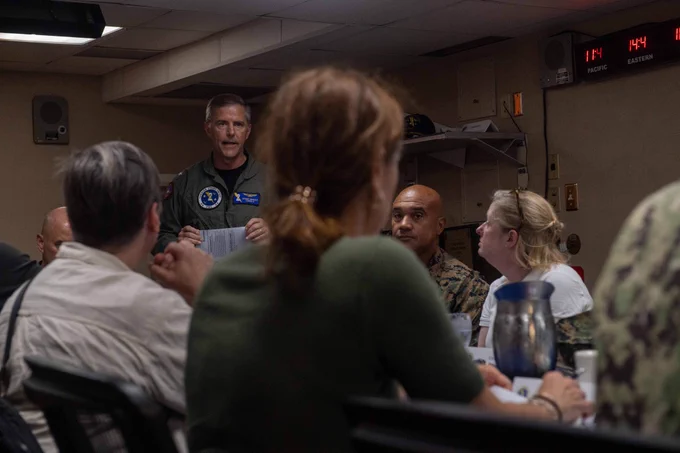 Rear Adm. Marc Miguez, commander, Carrier Strike Group Two, briefs distinguished visitors.