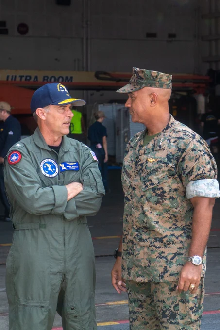 Rear Adm. Marc Miguez, commander, Carrier Strike Group Two, left, greets Lt. Gen. Brian W. Cavanaugh, commander, Marine Forces Command.