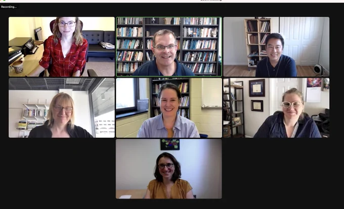 A group shot of the committee after a successful defense, all with happy smiles.