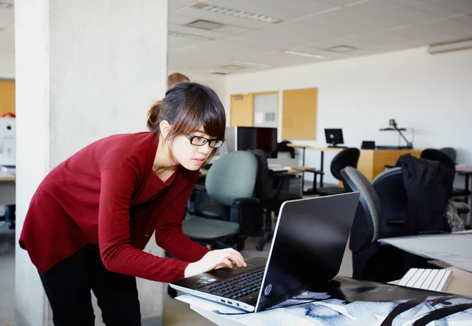 A student typing on a laptop.