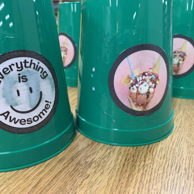 Everything is awesome tags on green cups along with a picture of an ice cream sundae.