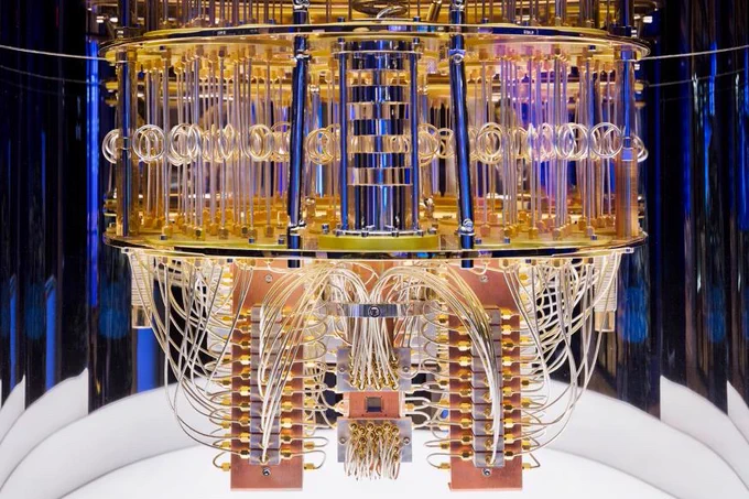 A quantum computer, with blue, gold and translucent components and wiring and lots of computer chips visible.