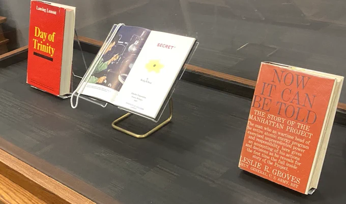 Photo of display case in the 5th Floor Special Collections at OU Libraries (with 3 books, including Leslie Grove's "Now It Can Be Told")