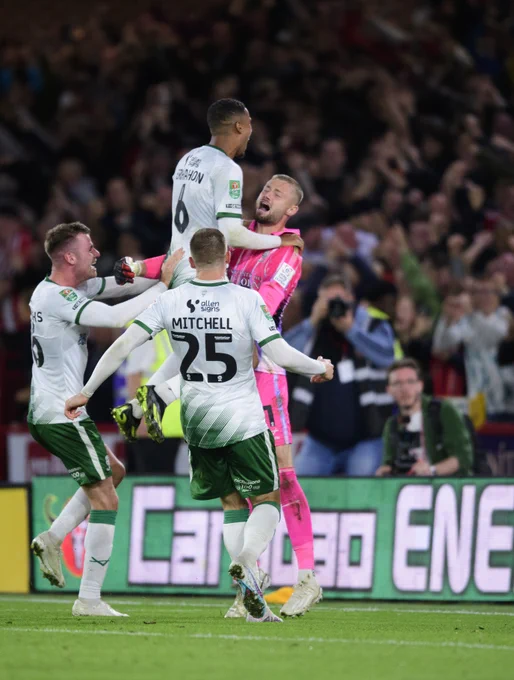 Jensen celebrates the penalty shootout win with team-mates at Bramall Lane.