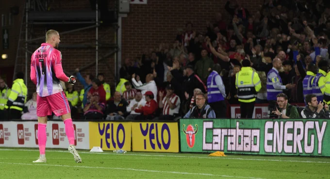 Jensen celebrates the penalty shootout win at Bramall Lane.