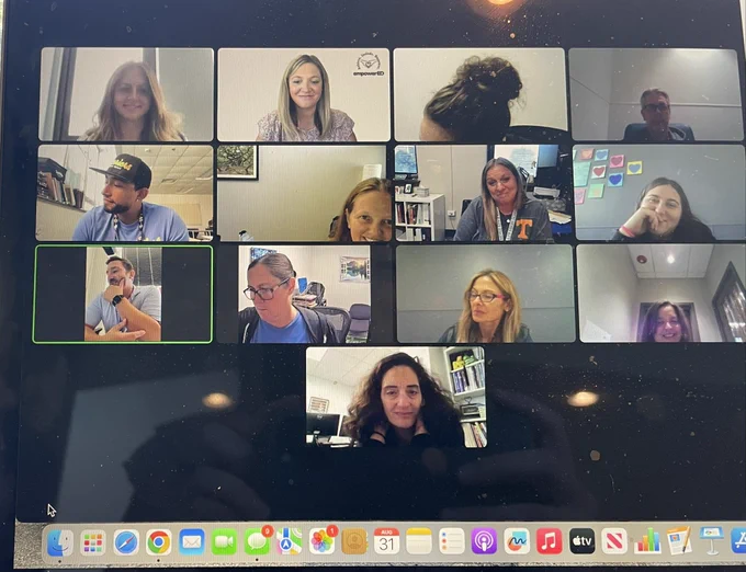 This picture shows a grid of twelve teachers participating in a virtual meeting. Most adults are smiling, and looking straight ahead at the screen.
