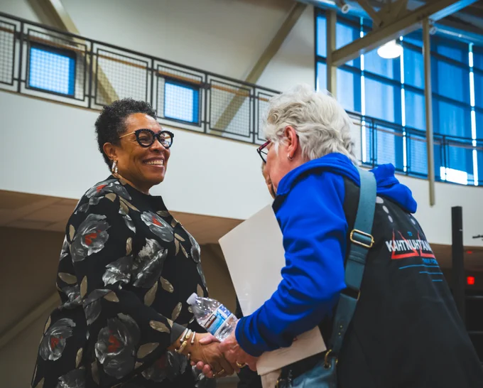 Secretary Marcia L. Fudge shaking hands with someone.
