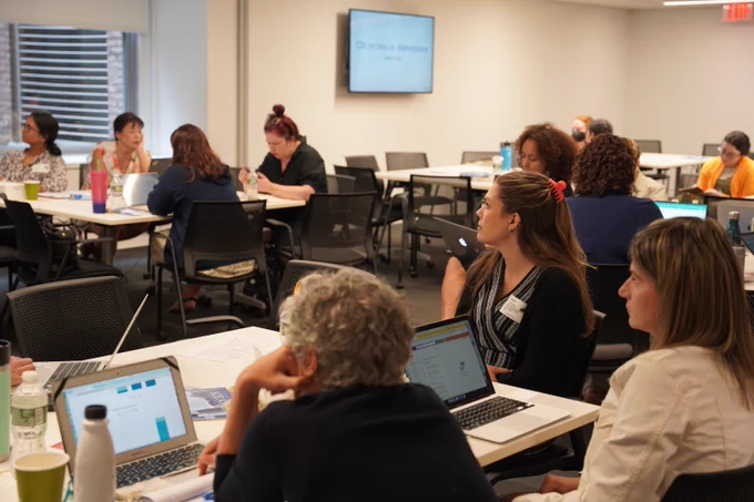 This photo shows a group of new librarians sitting through a training session.
