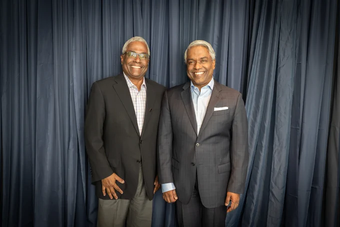A photograph of Thomas Kurian and George Kurian.