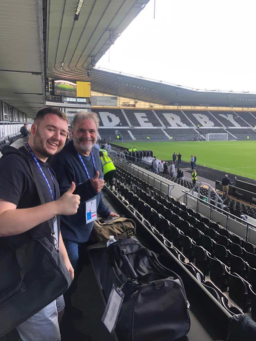 Two of our commentators with their thumbs up, with the Pride Park pitch in the background.