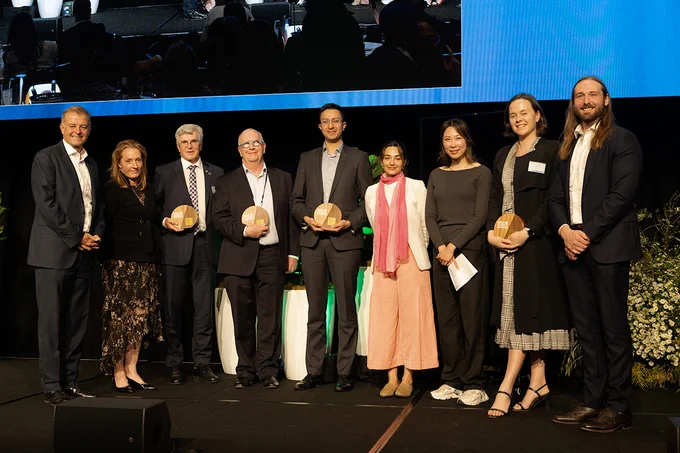 Photo of winners of the annual IGCC Summit Climate Awards on stage holding their awards. L-R: IGCC Chair, Stephen Dunne. IGCC CEO Rebecca Mikula-Wright. Professor Mark Howden ANU, Ian Woods, Saksham Malhotra (for Akaash Sachdeva) HESTA. Marwa Curran, IGCC. Dani Siew, IGCC. Zoe Whitton, Pollination. Michael Bones, IGCC.