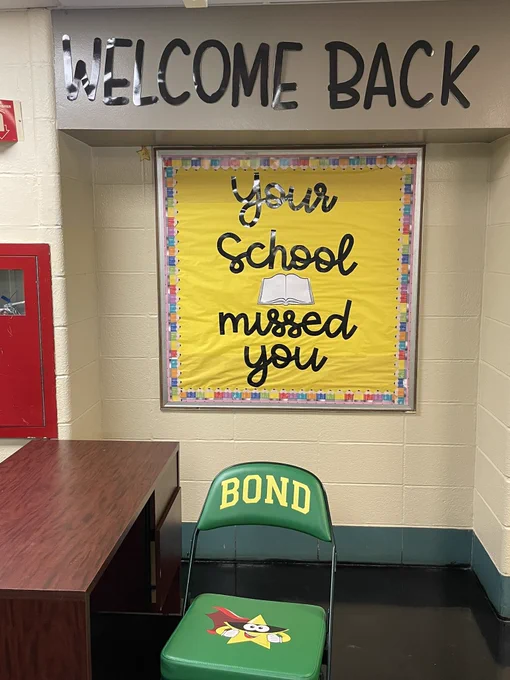 Welcome back sign with yellow bulletin board “your school missed you” and Bond green and yellow chair