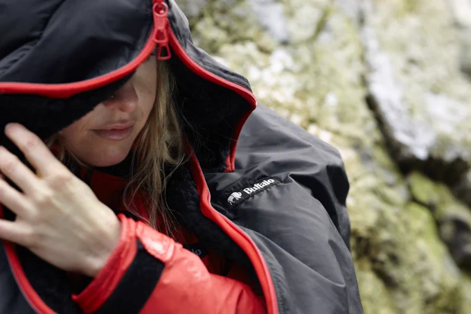 Women zipping up a warm sleeping bag that was manufactured in Sheffield, UK.