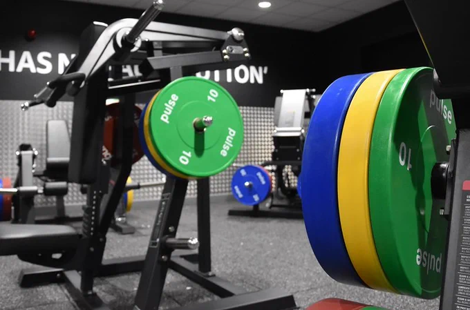 Weight plates on barbell in gym