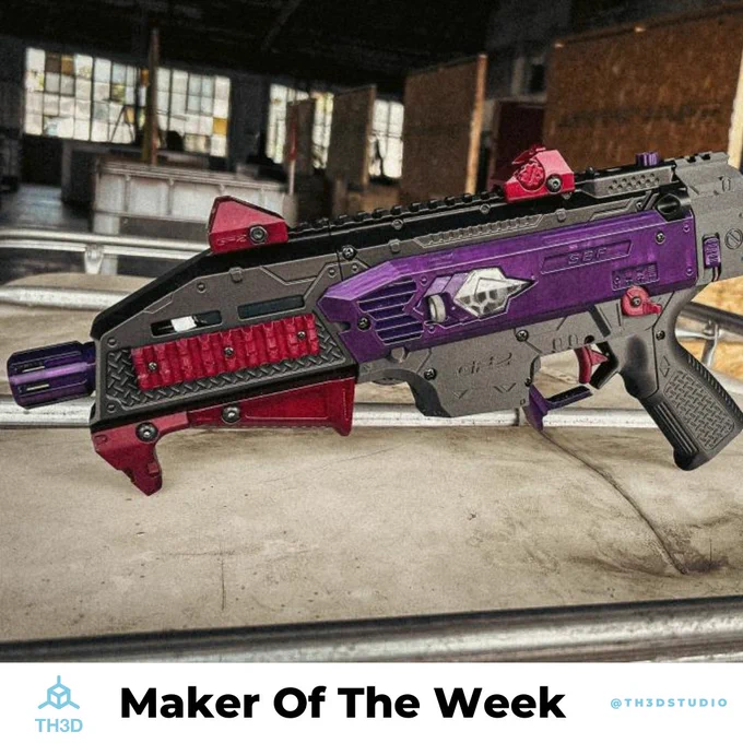 An image of a custom nerf blaster in grey, purple, and red.