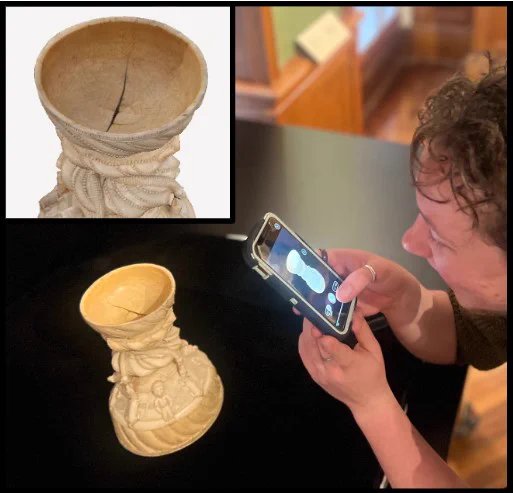 A person uses a phone for a 3D scanner, poised over a detailed sculpture of a chalice shape. There is a detail of the rendered scan in the upper left, emphasizing a crack in the center of the cup.