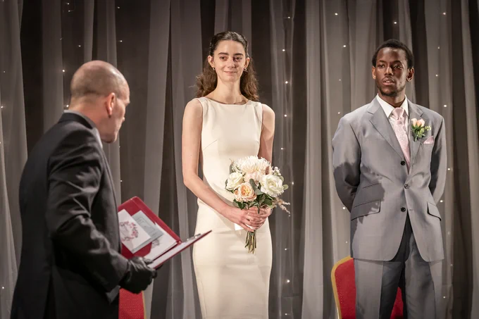 Bride, groom and wedding celebrant.
