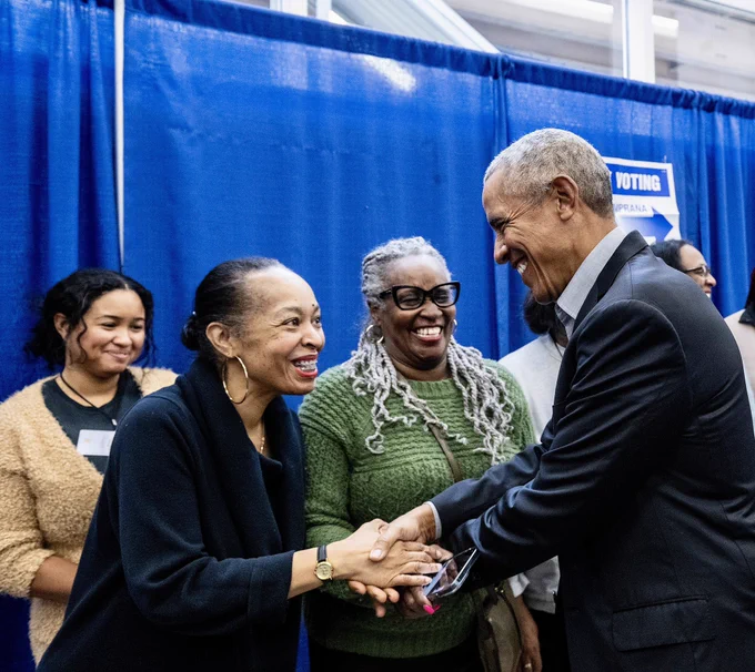 President Obama shakes hands with a poll worker after voting in Chicago.
