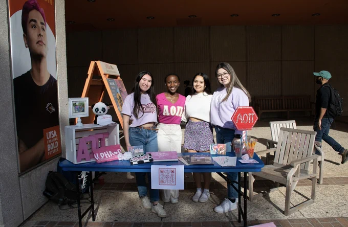 UTSA's chapter of Alpha Omicron Pi tables outside the McKinney Humanities building.