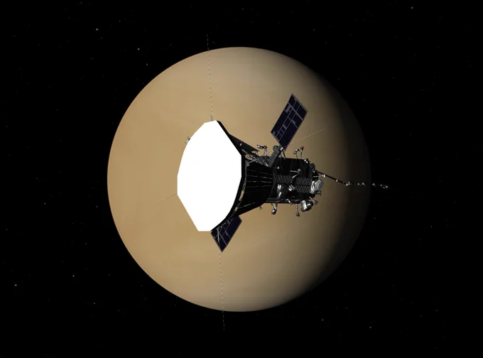 Simulated view of the Parker Solar Probe spacecraft framed by the nearly full disc of Venus in the background, against the blackness of space. The probe is distinguished by a large, flat, white heat shield at the front of its body, on the side facing the bright sunlight.