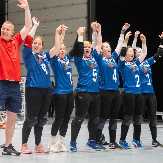The team with arms aloft celebrating getting through to the quarter finals