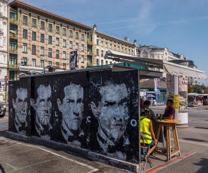 Four portraits of the Austrian singer Falco in front of Art Nouveau buildings in Vienna at Wienzeile