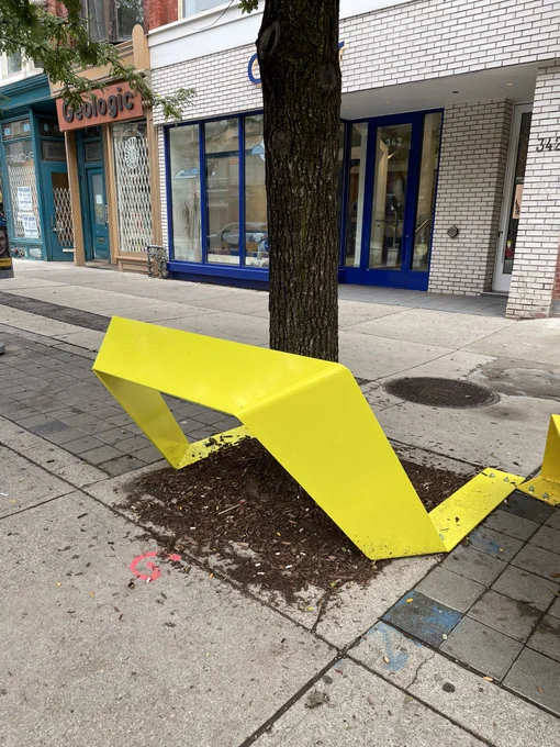 Photo of colourful street furniture (this one is a leaning bench)