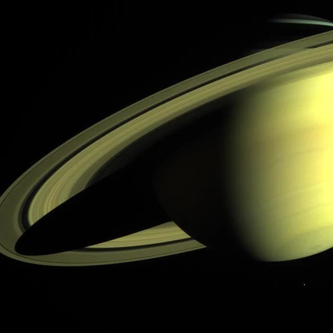 The Cassini-Huygens spacecraft returned this image of Saturn on May 16, 2004, when its imaging science subsystem narrow-angle camera was too close to fit the entire planet in its field-of-view. Cassini is still about 20 million kilometers (12.4 million miles) away and only 36 days from reaching Saturn. Cassini has two cameras, a wide angle and narrow angle. This narrow angle image was made using a combination of three filters (red, green, blue) and was taken at a range of 24.3 million kilometers (15.1 million miles). The view is from 13 degrees below the equator. Enceladus, one of Saturn's 31 known moons, appears near the south pole at the bottom of the image.

