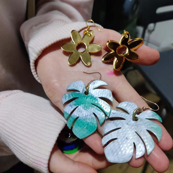 Earrings in the shape of tropical leaves and flowers - 2D shapes cut out of shiny and colourful plastic
