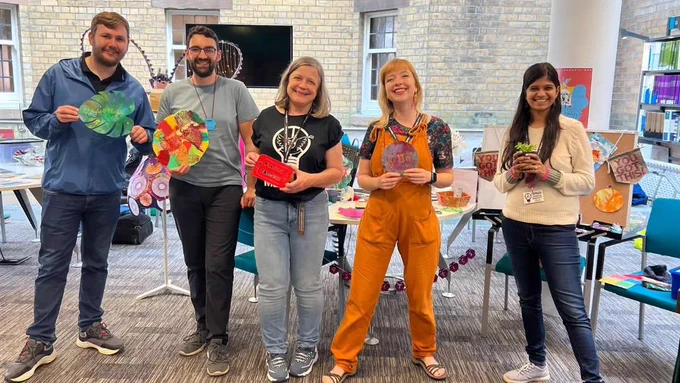 The Plastic Tactics team at liverpool makefest earlier this year, holding colourful plastic shapes such as leaves, logos, maths and plant pots
