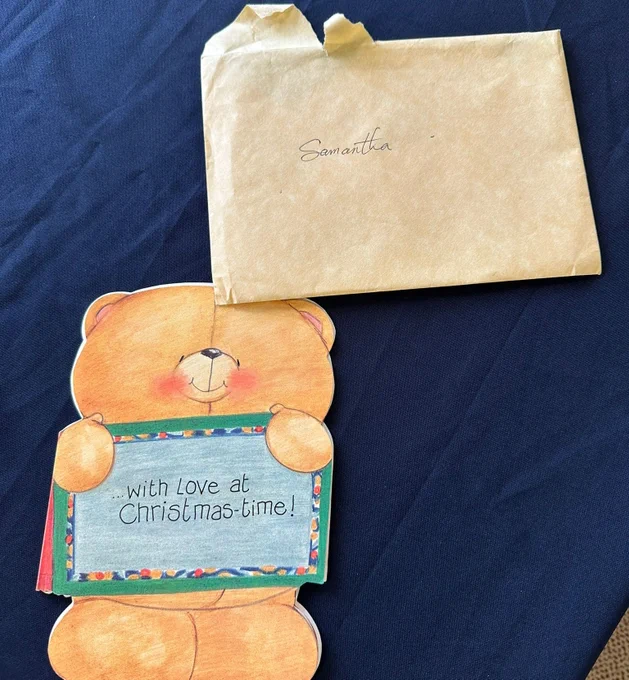 A Christmas card in the shape of a bear, with the caption "With love at Christmas time!" and an envelope with the name Samantha on it.